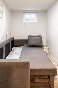 a large bed in a room with a couch at Cozy nest basement unit in Hamilton