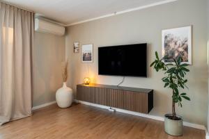 a living room with a flat screen tv on a wall at Spacious Villa located in Beautiful High Coast in Domsjö