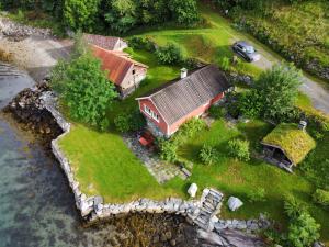 an aerial view of a house on an island in the water at Bodvarstova in Stryn