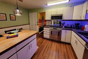 a kitchen with white cabinets and a wooden counter top at Rochester Kodak Themed 2 Bedroom Apt With Parking in Rochester