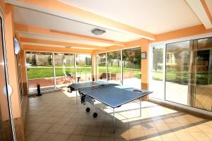 a room with a ping pong table in it at Villa Sutomore in Sutomore
