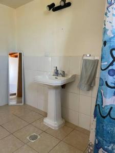 a bathroom with a white sink and a mirror at Lindo depto en inmejorable ubicación in Caldera