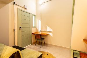 a small room with a desk and a bed at Casa Savana in São Paulo