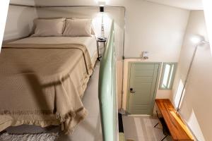 a bedroom with a bed in a small room at Casa Savana in São Paulo