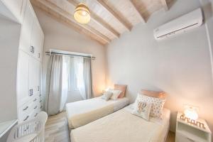 a bedroom with two beds and a window at Corfu Cicada House in Corfu Town