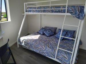a bedroom with two bunk beds and a bed at The Bowentown in Bowentown