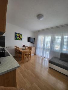 eine Küche und ein Wohnzimmer mit einem Tisch und einem Sofa in der Unterkunft Apartments Jelica in Trogir