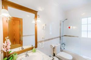 a bathroom with a toilet and a sink and a shower at Villa Tuduri in Binibeca +9 photos