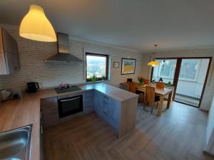 a kitchen with a table and a dining room at Ferienhaus Berghof Usch in Usch