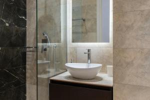 a bathroom with a sink and a glass shower at Voda Luxury Residence #301 in Athens