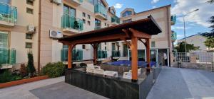 a gazebo in the courtyard of a building at Domador Rooms & Apartments in Budva