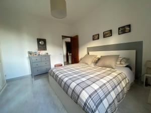 a bedroom with a bed and a dresser in it at Sunrise apartament in Monterosso al Mare
