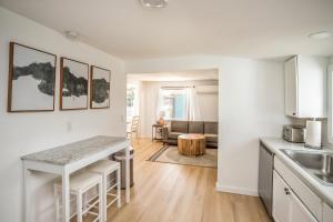 a kitchen and living room with a counter and a table at Cozy 2 Bedroom Home, Private Backyard with Hot Tub in Seaview