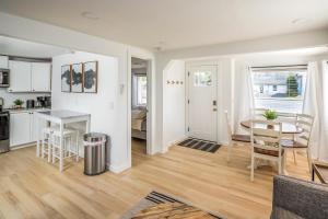 a kitchen and living room with a table and chairs at Cozy 2 Bedroom Home, Private Backyard with Hot Tub in Seaview