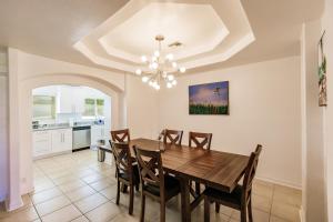 a dining room with a table and chairs at NEW! Dock Canal Family Home w/Pool & Gulf Access! in North Fort Myers