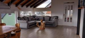 a living room with a couch and a table at Apartman OGNJIŠTE in Kupres +20 photos