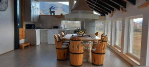 a kitchen with a wooden table and chairs at Apartman OGNJIŠTE in Kupres