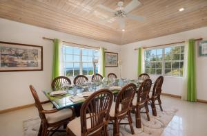 a dining room with a table and chairs at Fort Shelley in Cades Bay