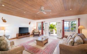 a living room with a couch and a table at Fort Shelley in Cades Bay