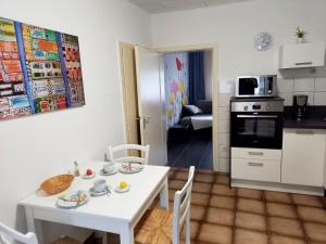 a kitchen and dining room with a white table and chairs at Ferienwohnung Uni Koblenz in Koblenz