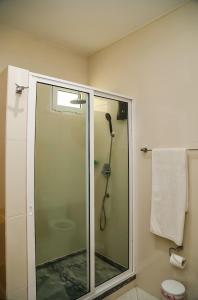 a shower with a glass door in a bathroom at Cruzeiro Guest House in São Filipe