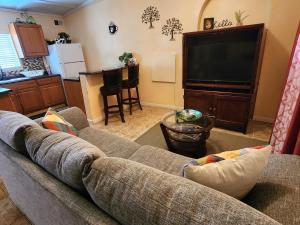 a living room with a couch and a flat screen tv at Dolan Springs, Grand Canyon Skywalk in Dolan Springs