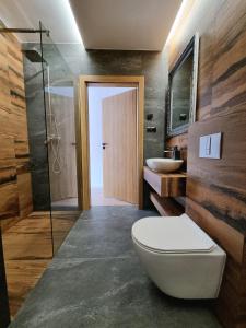 a bathroom with a toilet and a sink at Apartamenty Nowa Osada - by VillaOlimpijska2 in Wisła