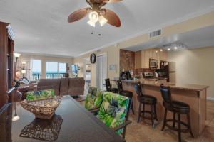 a kitchen and living room with a table and chairs at Island Echos #2E in Fort Walton Beach