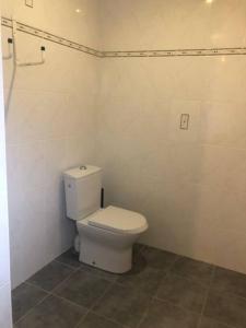 a bathroom with a white toilet in a room at LES IRIS 2 T2 45m2 à 200m des thermes in Eugénie-les-Bains