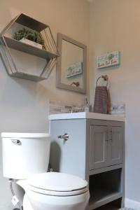 a bathroom with a white toilet and a sink at Luxury House with delightful beach Style! in Dania Beach