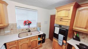 a kitchen with a sink and a window at Rose Villa- Great For Long & Short Stays!!! in Gillingham