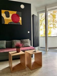 a living room with a couch and a table at Smart Apartment Ogrodowa in Warsaw