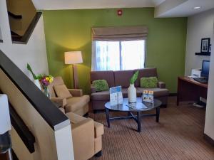 a living room with a couch and a table at Sleep Inn in Fredericksburg