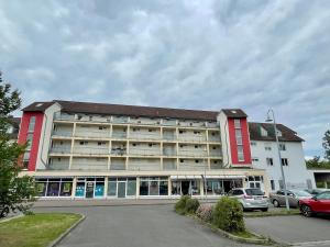 a large building with cars parked in a parking lot at Moderne Wohnung mit Sauna nahe Burg im Spreewald in Vetschau