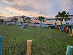 a park with a playground with play equipment and palm trees at Tree Bies Resort Subaúma - Apartamento particular in Subaúma