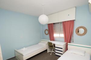 リマソールにあるprivate room in a shared flat at best locationのベッド2台とデスクが備わる客室です。