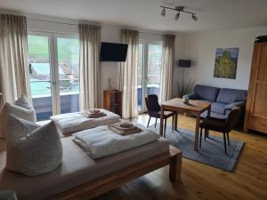 a bedroom with a bed and a living room at Mosel-Auszeit in Brauneberg