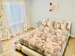a bedroom with a bed with a comforter and a window at Artsy home by Air Force Academy with office space in Colorado Springs