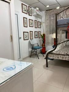 グアヤキルにあるCasa Paraísoのベッド、テーブル、椅子が備わる客室です。