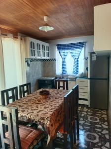 a kitchen with a table and chairs and a kitchen with a table and a kitchen at cabañas Te Pito Kura in Hanga Roa