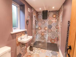 a bathroom with a shower and a sink at The Stables in Scarborough +21 photos