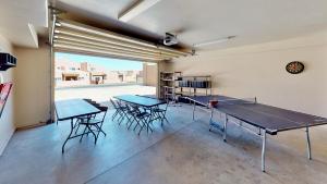 a room with two ping pong tables and chairs at Cairn House #4A7 in Moab