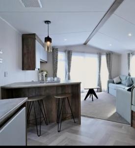a kitchen and living room with a large island at Q8 ocean edge caravan park in Heysham