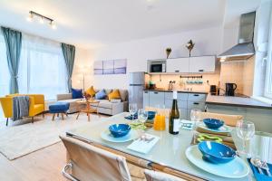 a kitchen and living room with a table and chairs at Feel Home DeLuxe CORVIN # FREE PARKING # AC # Elevator in Budapest