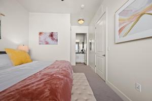 a white bedroom with a bed and a bathroom at King BD-City View-SLC Walking Wonderland- in Salt Lake City