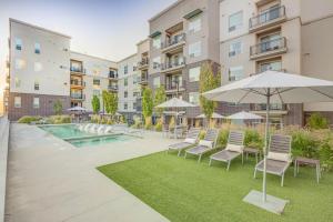 a courtyard with chairs and an umbrella and a pool at King BD-City View-SLC Walking Wonderland- in Salt Lake City
