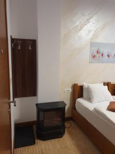 a bedroom with a bed and a table in a room at Apartment B026 - Aparthotel Vučko in Jahorina