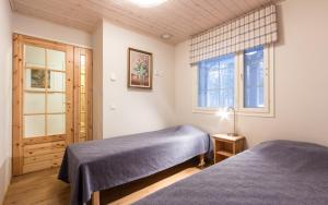 a bedroom with two beds and a window at Tapion Tupa in Kalajoki