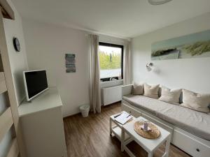 een woonkamer met een bank en een tafel bij Ferienvermietung Strandnah in Großenbrode