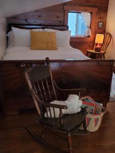 a bedroom with a bed and a rocking chair at Rosedale Chapel Bed and Breakfast in Steinbach